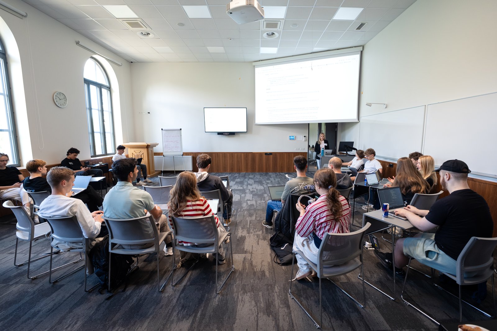 The workshop room at Estonian Business School, with participants working on laptops.