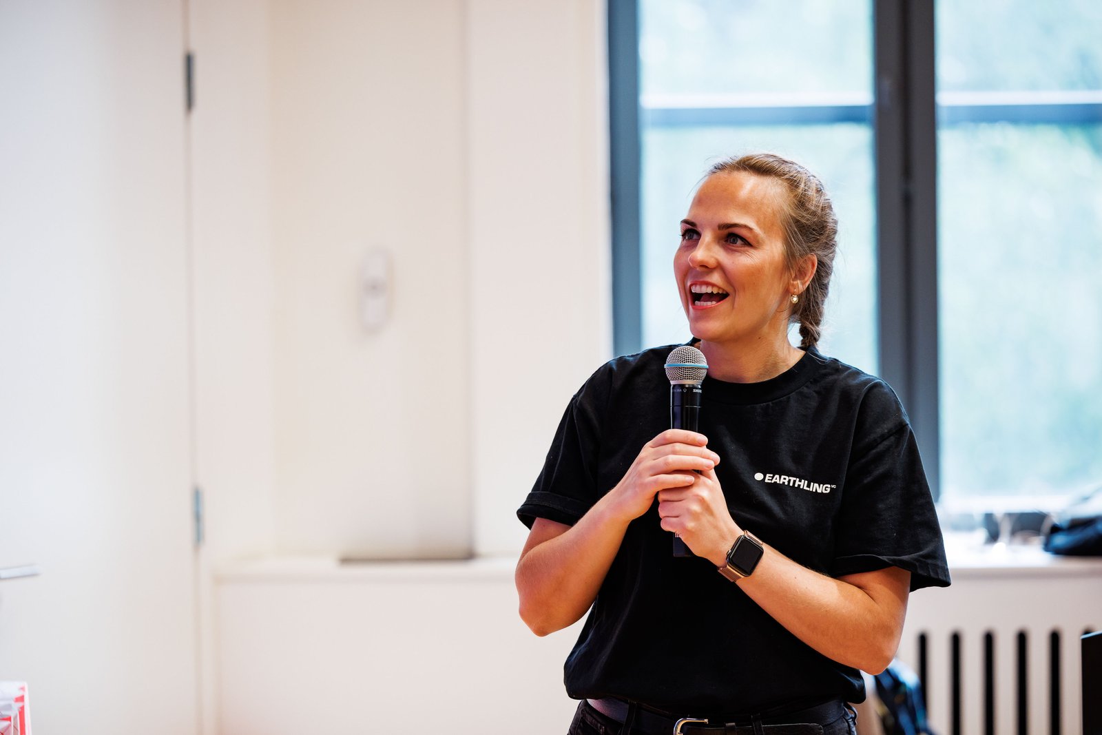 A host speaking into a microphone during Build Day.