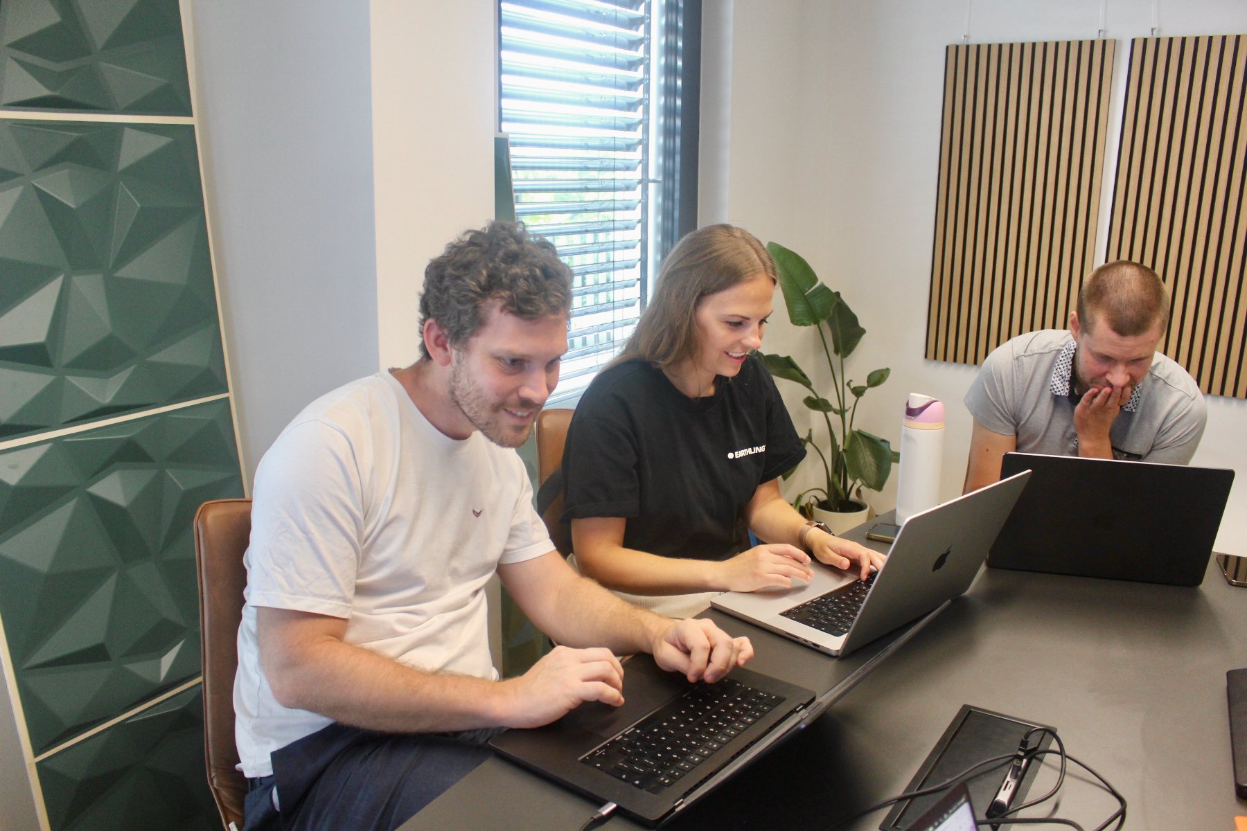 Members of both teams at their laptops, building the integration between Elnora and the UniteLabs SDK.